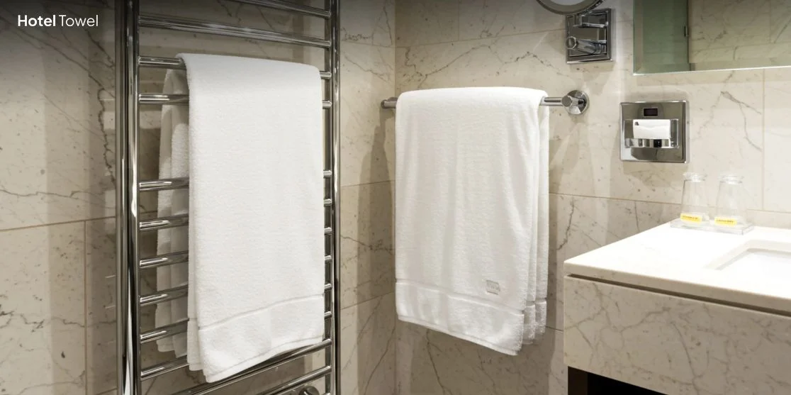 White hotel towels in modern bathroom.